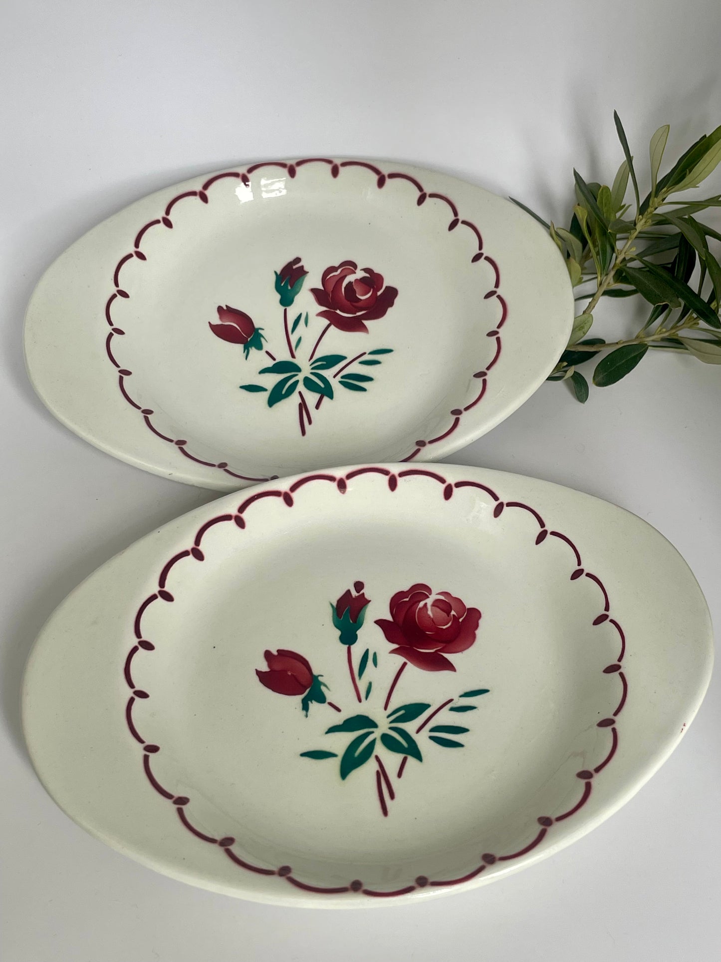Two Badonviller earthenware dishes with red rose motif.