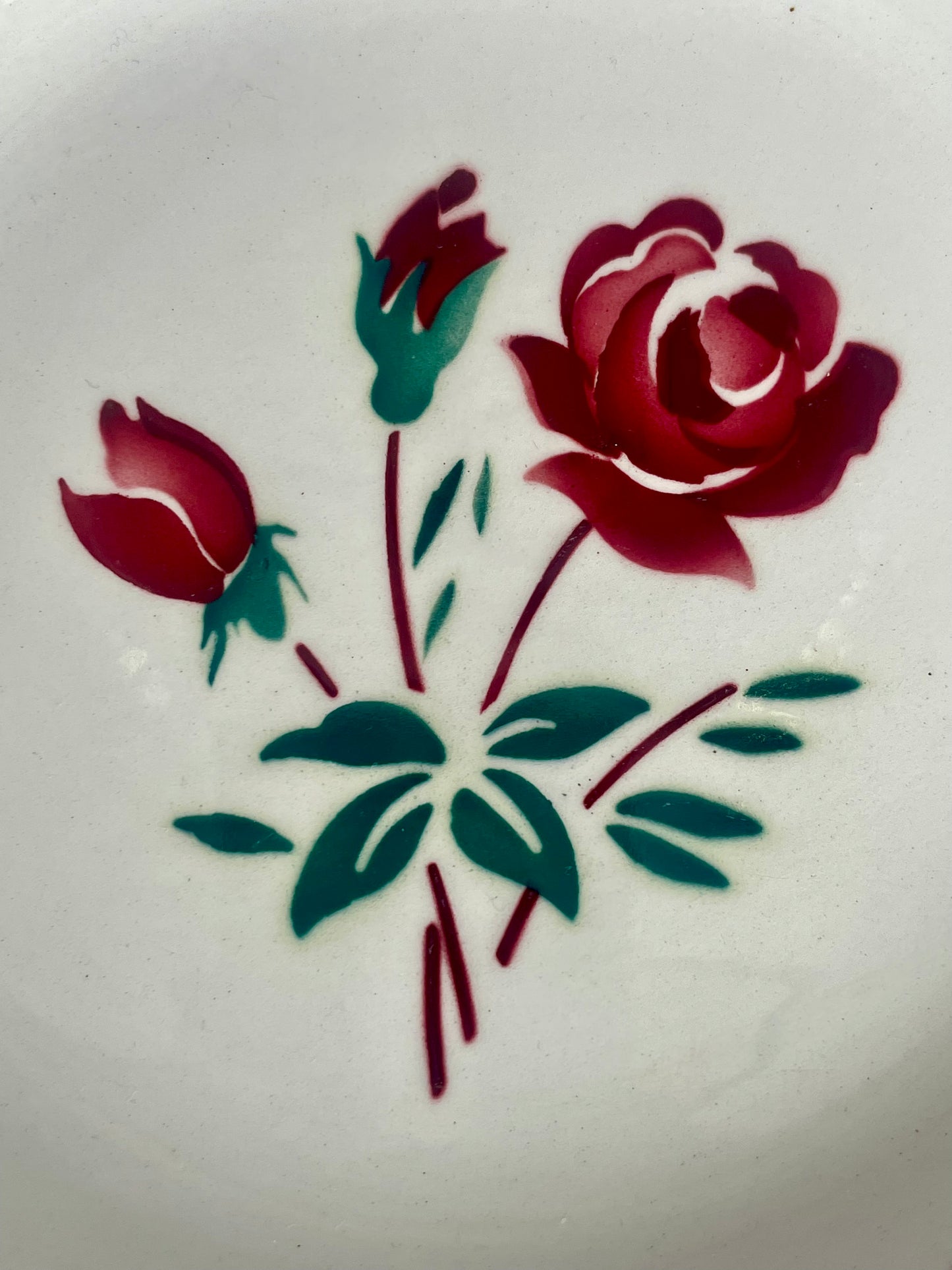 Two Badonviller earthenware dishes with red rose motif.